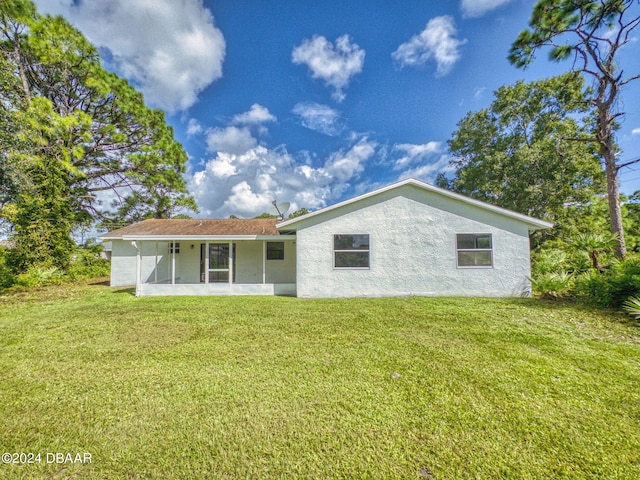 back of property with a yard