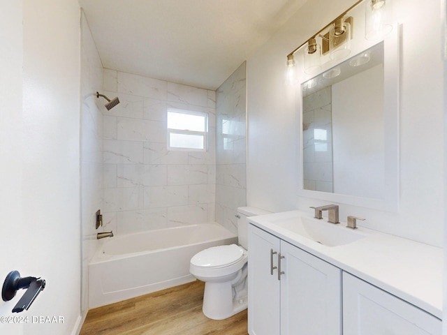 full bathroom featuring wood-type flooring, vanity, toilet, and tiled shower / bath combo