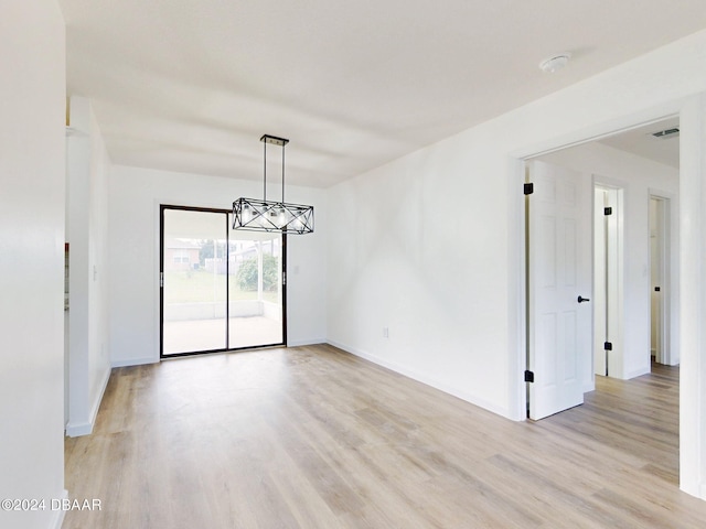 empty room with light hardwood / wood-style flooring