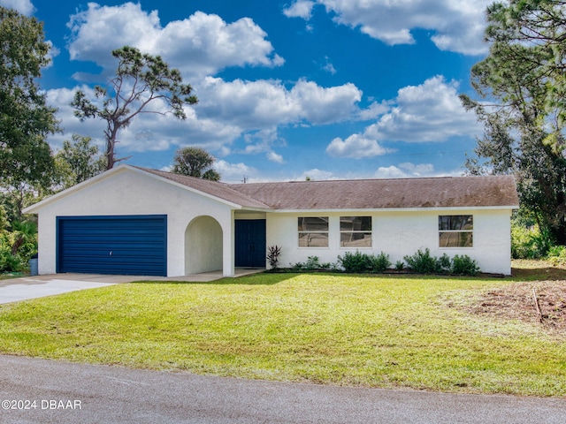 single story home featuring a front lawn and a garage