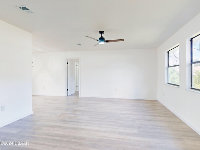 spare room with light wood-type flooring and ceiling fan