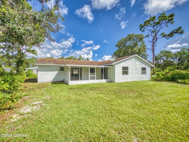 back of property featuring a lawn