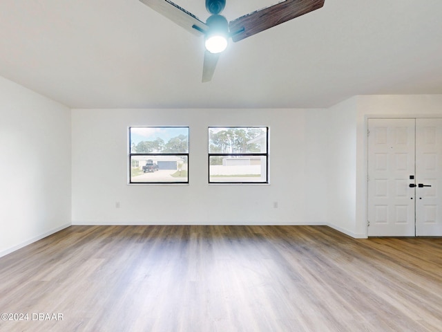 empty room with light hardwood / wood-style floors and ceiling fan