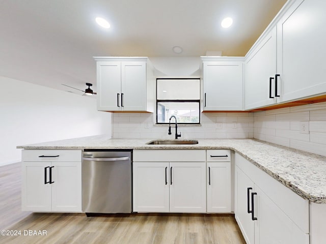 kitchen with white cabinetry, stainless steel dishwasher, sink, and light hardwood / wood-style floors