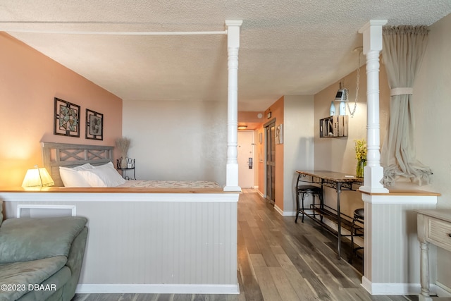 bedroom featuring hardwood / wood-style floors and a textured ceiling