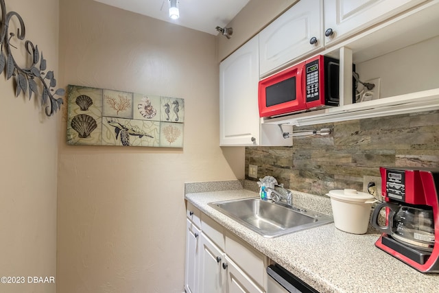 kitchen with white cabinetry, sink, and tasteful backsplash