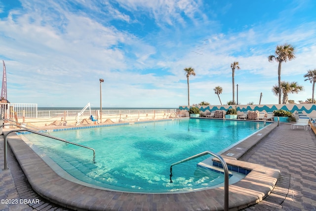 view of pool with a water view