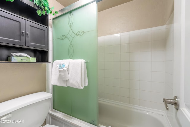 bathroom with tiled shower / bath combo and toilet