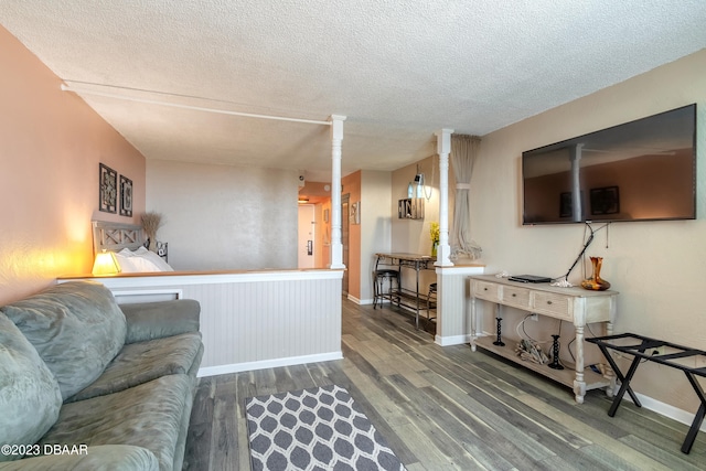 living room with hardwood / wood-style floors and a textured ceiling