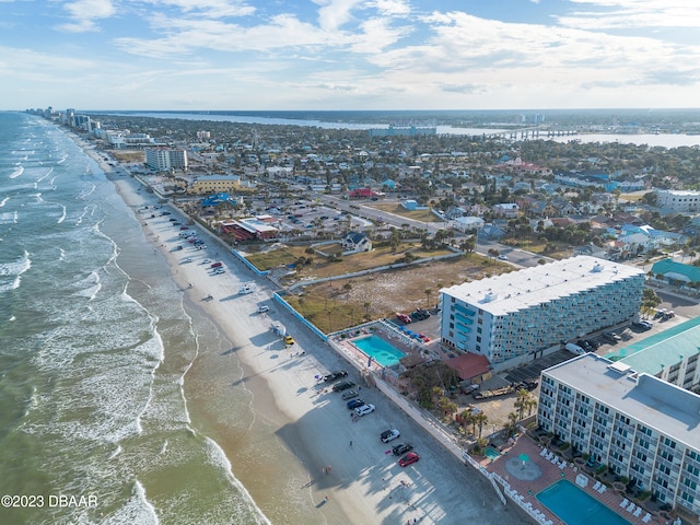 birds eye view of property with a beach view and a water view