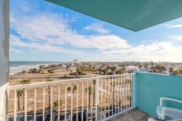 balcony featuring a beach view and a water view