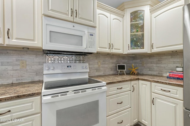 kitchen featuring white appliances, tasteful backsplash, and white cabinets