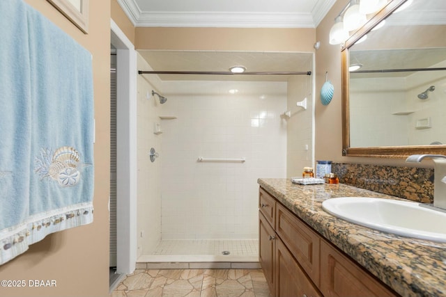 bathroom featuring crown molding, tile patterned floors, a tile shower, and vanity