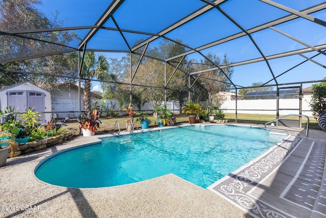 view of pool with a patio, glass enclosure, and a storage shed