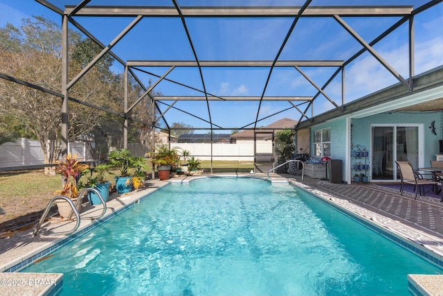 view of swimming pool with glass enclosure