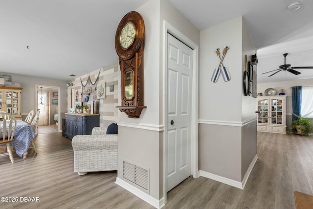 hall with hardwood / wood-style floors