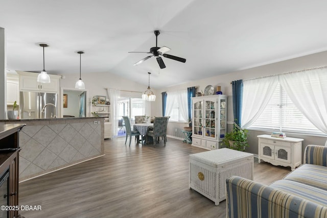 living room with lofted ceiling, ceiling fan, and dark hardwood / wood-style flooring