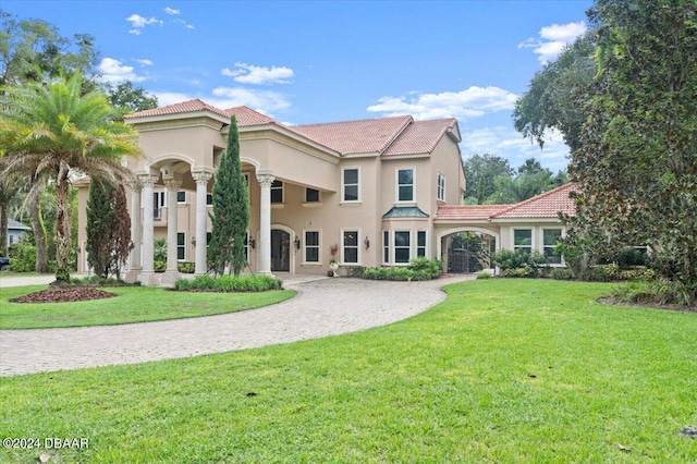 mediterranean / spanish-style home featuring a front lawn