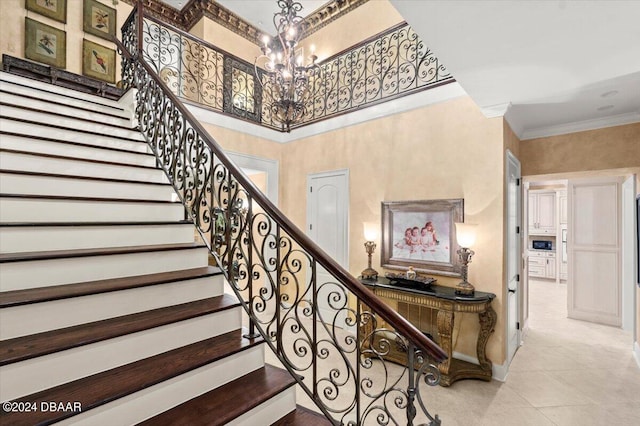 stairway featuring tile patterned floors, an inviting chandelier, and ornamental molding