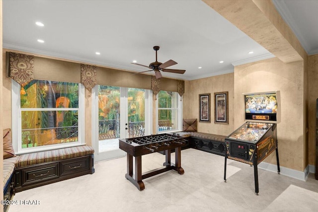 game room with ceiling fan and ornamental molding