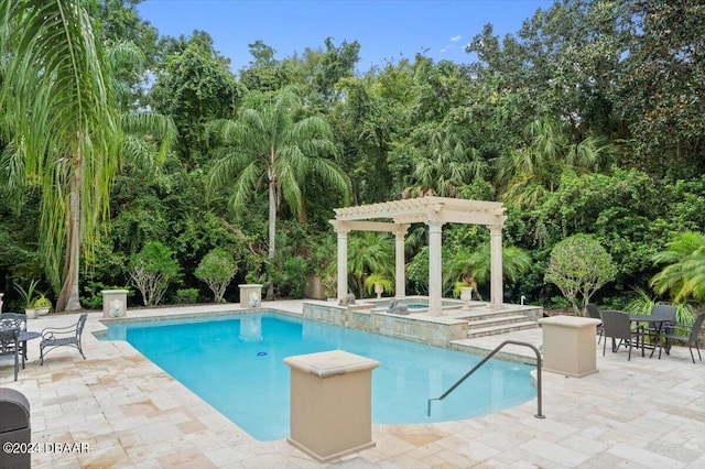 view of swimming pool featuring a patio, a pergola, and an in ground hot tub