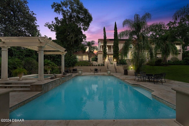 pool at dusk with a pergola and a patio area