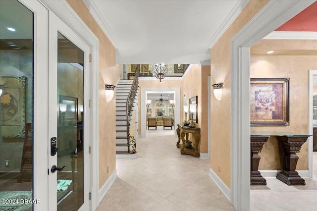 hall featuring a chandelier, french doors, and ornamental molding