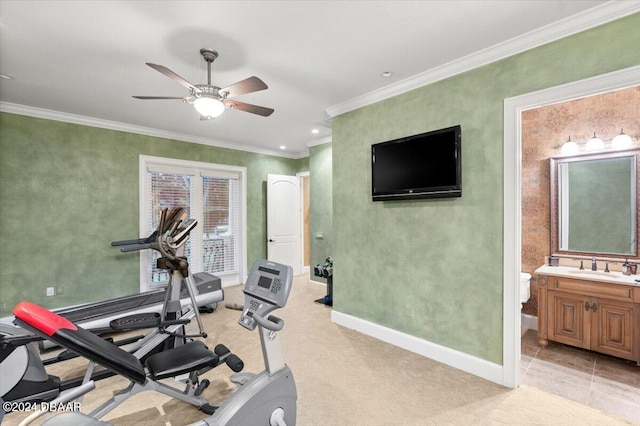 workout area with crown molding, sink, ceiling fan, and light tile patterned flooring