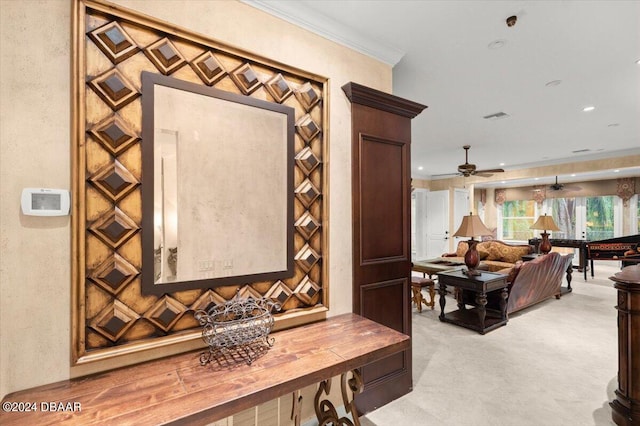 room details featuring ornamental molding, carpet floors, and ceiling fan