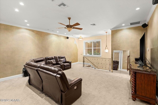 carpeted home theater featuring ceiling fan and crown molding