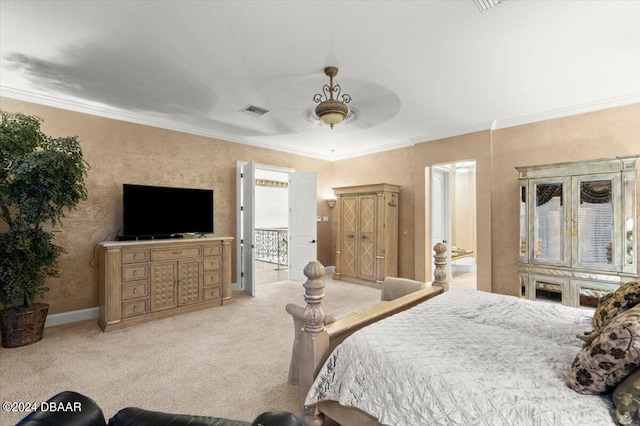 carpeted bedroom with ceiling fan and ornamental molding