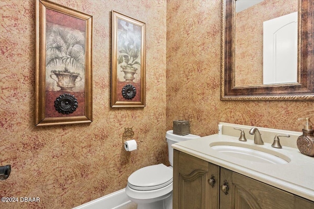 bathroom featuring toilet and vanity