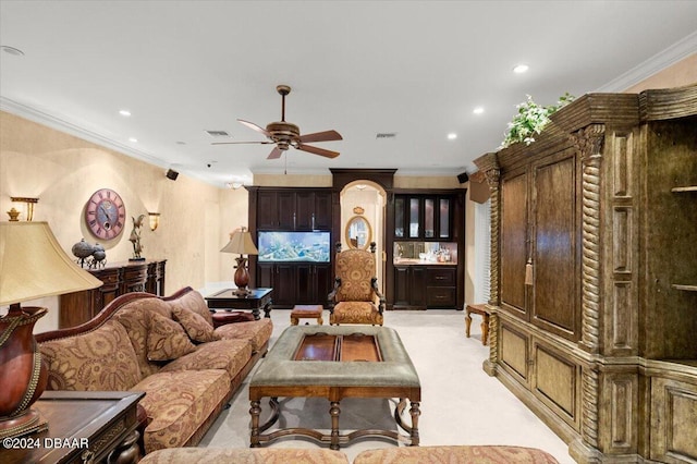 carpeted living room with ceiling fan and crown molding