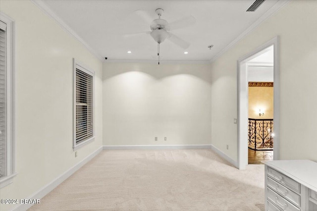 carpeted empty room featuring ornamental molding and ceiling fan