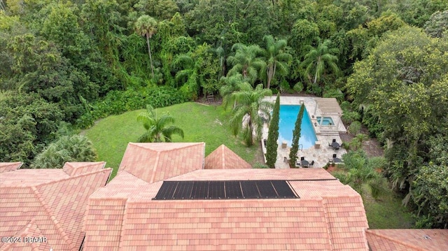 view of pool with a lawn