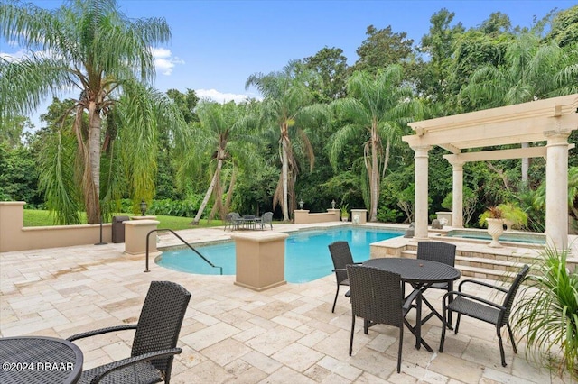 view of pool with a patio and an in ground hot tub