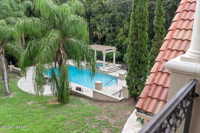 view of swimming pool featuring a yard, a patio, and a pergola