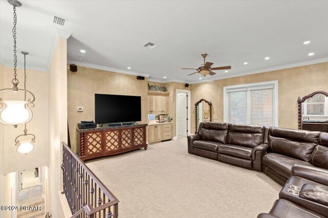 living room with light carpet, ceiling fan, and crown molding