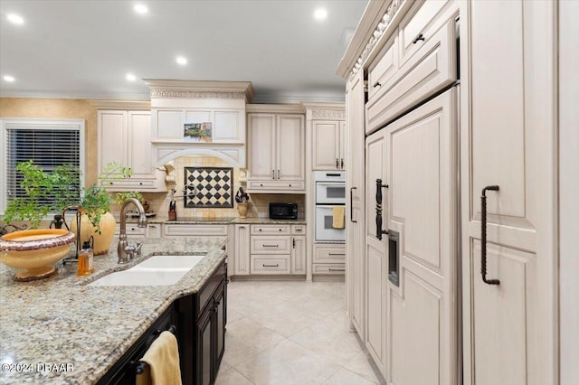 kitchen with black appliances, light stone counters, crown molding, decorative backsplash, and sink