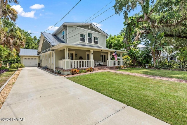 view of front of house featuring an outbuilding, a front lawn, a porch, and a garage