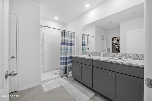 full bathroom featuring visible vents, a sink, a shower stall, and double vanity