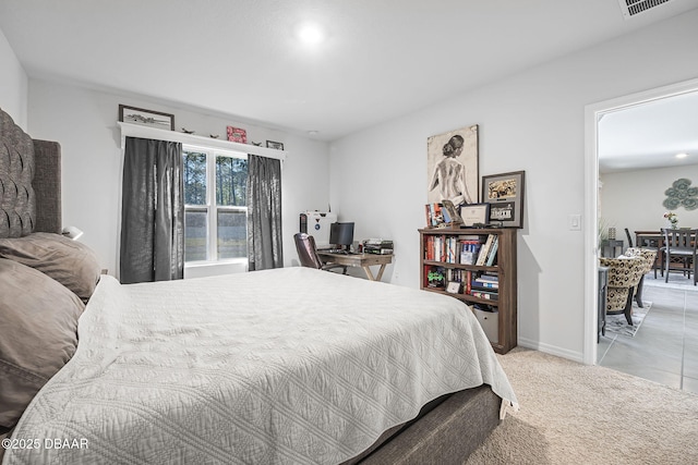 bedroom with light carpet, visible vents, and baseboards