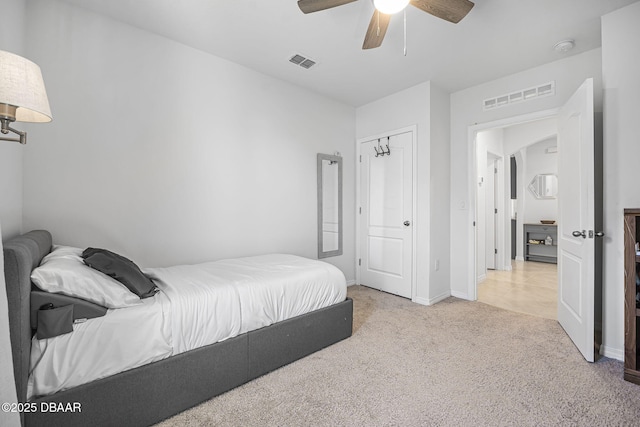 bedroom featuring a ceiling fan, carpet flooring, visible vents, and baseboards