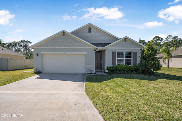 view of front of property with a front lawn, driveway, an attached garage, and fence