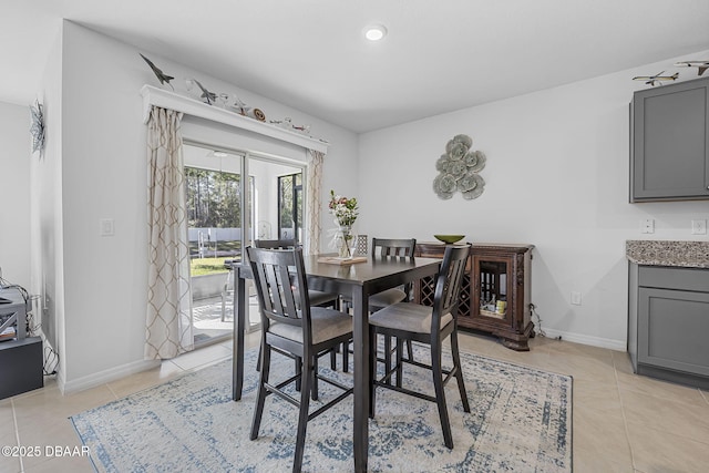 dining room featuring light tile patterned floors and baseboards