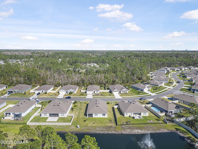 bird's eye view featuring a residential view, a water view, and a wooded view