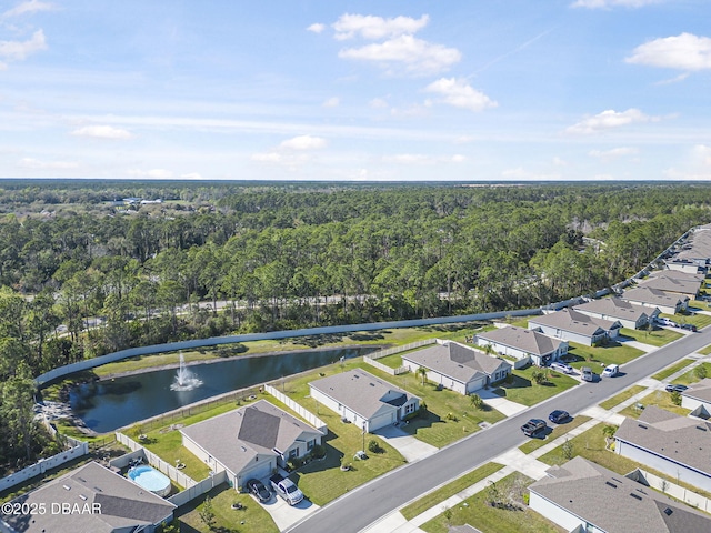 birds eye view of property with a water view, a residential view, and a view of trees