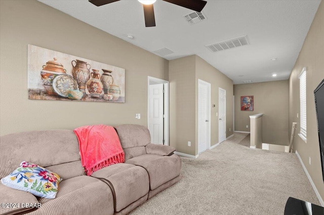 carpeted living room with ceiling fan