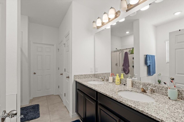 bathroom featuring vanity, tile patterned flooring, and a shower with shower door