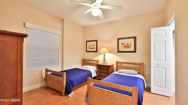 bedroom featuring baseboards, a ceiling fan, and light tile patterned floors